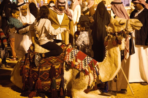 Children enjoying camel rides, Janadiriyah Festival, 2014